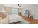 Main bedroom featuring hardwood floors, neutral paint, bright windows, and modern decor at 505 Timber Pond Dr, Brandon, FL 33510