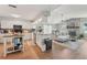 Bright open-concept living area with a kitchen that flows into a cozy living room with a stone fireplace at 505 Timber Pond Dr, Brandon, FL 33510