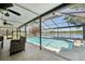 Enjoy the screened-in pool with lake views, perfect for cooling off on a hot day at 505 Timber Pond Dr, Brandon, FL 33510