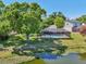 Beautiful backyard view featuring a screened-in pool with lovely backyard and pond at 505 Timber Pond Dr, Brandon, FL 33510