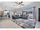 Bright living room with large sectional, neutral rug, and sliding glass doors to the pool area at 5050 Alderbrook Pl, Land O Lakes, FL 34638