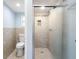 Modern bathroom featuring a walk-in shower with stylish tile surround and a toilet at 5103 Town N Country Blvd, Tampa, FL 33615