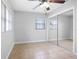 Bedroom featuring mirrored closet doors, tile floors and a ceiling fan at 5103 Town N Country Blvd, Tampa, FL 33615
