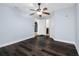 Simple bedroom with multiple doors to other rooms and dark laminate floors at 5103 Town N Country Blvd, Tampa, FL 33615