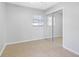 Well-lit bedroom with mirrored closet doors and neutral tile flooring at 5103 Town N Country Blvd, Tampa, FL 33615