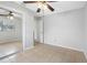 Bedroom featuring tiled floor, mirrored closet door, a ceiling fan and natural light at 5103 Town N Country Blvd, Tampa, FL 33615