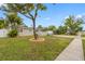 Charming single-story home features lush landscaping and a convenient carport at 5103 Town N Country Blvd, Tampa, FL 33615