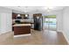 Modern kitchen boasts stainless steel appliances, granite countertops, and sliding glass doors to the pool at 5103 Town N Country Blvd, Tampa, FL 33615