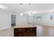 Open-concept living room featuring tile floors and abundant natural light from the large windows at 5103 Town N Country Blvd, Tampa, FL 33615