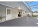 Enclosed patio with gray flooring, an outdoor sink, and views of the backyard at 5103 Town N Country Blvd, Tampa, FL 33615