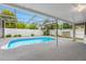 A screened-in pool area with a sleek gray pool deck and privacy fence at 5103 Town N Country Blvd, Tampa, FL 33615