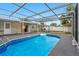 Outdoor pool featuring pool enclosure, updated deck and a shed at 5103 Town N Country Blvd, Tampa, FL 33615