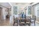 Formal dining room, featuring stylish furnishings, mirrors, and tiled floors at 5309 Oxford Gray Rd, Wesley Chapel, FL 33545