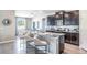 Contemporary kitchen showcasing granite counters, a breakfast bar, and dark wood cabinetry at 5309 Oxford Gray Rd, Wesley Chapel, FL 33545