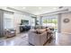 Comfortable living room featuring tile floors, large windows, and contemporary furnishings at 5309 Oxford Gray Rd, Wesley Chapel, FL 33545