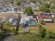 Aerial view of a home with a screened-in pool and backyard access to a tranquil lake at 8024 Timberlane Dr, Tampa, FL 33615