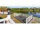 Lake view from a backyard deck with white railings, with table and chairs at 8024 Timberlane Dr, Tampa, FL 33615