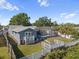 Aerial view of a fenced backyard with pool, screen enclosure, deck, and patio at 8024 Timberlane Dr, Tampa, FL 33615