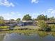 Backyard view featuring a pool, deck, and lake access, perfect for outdoor living at 8024 Timberlane Dr, Tampa, FL 33615