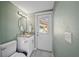 Well-lit bathroom with modern vanity and exterior door leading to a pool area at 8024 Timberlane Dr, Tampa, FL 33615