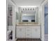Bathroom with a double sink vanity and well-lit mirror, providing ample space at 8024 Timberlane Dr, Tampa, FL 33615