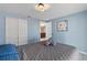 Inviting bedroom with double closet, soothing blue walls, and neutral bedding at 8024 Timberlane Dr, Tampa, FL 33615