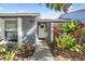 Welcoming front entrance with well-kept landscaping leading to a charming home at 8024 Timberlane Dr, Tampa, FL 33615