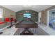 Spacious game room with a pool table, bar, and access to the backyard at 8024 Timberlane Dr, Tampa, FL 33615