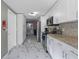 Open kitchen design featuring stainless appliances, white cabinets, and sleek countertops at 8024 Timberlane Dr, Tampa, FL 33615