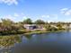 Picturesque lake view with a home featuring a backyard and access to waterfront living at 8024 Timberlane Dr, Tampa, FL 33615