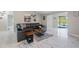 Bright living room with modern flooring and a view of the screened-in pool at 8024 Timberlane Dr, Tampa, FL 33615