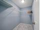 Spacious walk-in closet with wire shelving and attractive tile flooring, perfect for organization at 8024 Timberlane Dr, Tampa, FL 33615