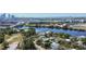 Scenic aerial view of a waterfront neighborhood with lush trees and a distant cityscape at 803 W Columbus Dr, Tampa, FL 33602