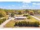 Aerial view shows house, land, RV, and covered parking on sunny day at 8122 Ehren Cemetery Rd, Land O Lakes, FL 34639