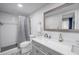 Updated bathroom features a tiled shower, modern vanity, and stylish patterned floor tiles at 1101 39Th Ne Ave, St Petersburg, FL 33703