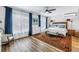 Bright bedroom with hardwood floors, large windows with curtains, and stylish furnishings at 1101 39Th Ne Ave, St Petersburg, FL 33703