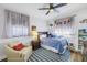 Bright bedroom with blue accents, ceiling fan, and cheerful nautical-themed decor at 1101 39Th Ne Ave, St Petersburg, FL 33703