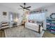 Charming bedroom featuring stylish decor, a cozy daybed, and ample natural light from the large windows at 1101 39Th Ne Ave, St Petersburg, FL 33703
