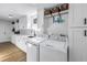 Well-equipped laundry room with white cabinets, countertops, and modern appliances at 1101 39Th Ne Ave, St Petersburg, FL 33703