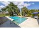Inviting backyard pool with a patio, palm trees, and an umbrella, perfect for relaxation and entertaining at 1101 39Th Ne Ave, St Petersburg, FL 33703