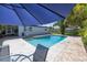 Relaxing pool area with patio seating under a blue umbrella, perfect for enjoying the outdoors at 1101 39Th Ne Ave, St Petersburg, FL 33703