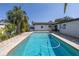 Refreshing pool with clear blue water, complemented by a patio area and tropical landscaping for relaxation at 1101 39Th Ne Ave, St Petersburg, FL 33703