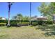 Lush backyard with manicured greenery, privacy hedges and views of neighboring homes at 12646 Carlby Cir, Tampa, FL 33626