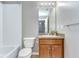 Well-lit bathroom with tile floors, a tub and shower combination, and a granite vanity top at 12646 Carlby Cir, Tampa, FL 33626