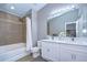 Well-lit bathroom with double sinks, and shower with tub combination at 12646 Carlby Cir, Tampa, FL 33626