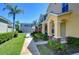 Multi-Gathering exterior view showing sidewalks, manicured lawns, and a view of garages in a residential neighborhood at 12646 Carlby Cir, Tampa, FL 33626