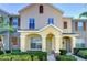 Inviting townhouse featuring a covered entry with decorative columns and lush landscaping at 12646 Carlby Cir, Tampa, FL 33626