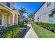 Multi-Gathering exterior shot displaying sidewalks and lawn bordered by shrubbery on a sunny day at 12646 Carlby Cir, Tampa, FL 33626