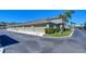 Row of garages with neutral paint and surrounded by green grass and blue skies at 12646 Carlby Cir, Tampa, FL 33626