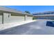 Attached garages in neutral paint with greenery and blue sky at 12646 Carlby Cir, Tampa, FL 33626